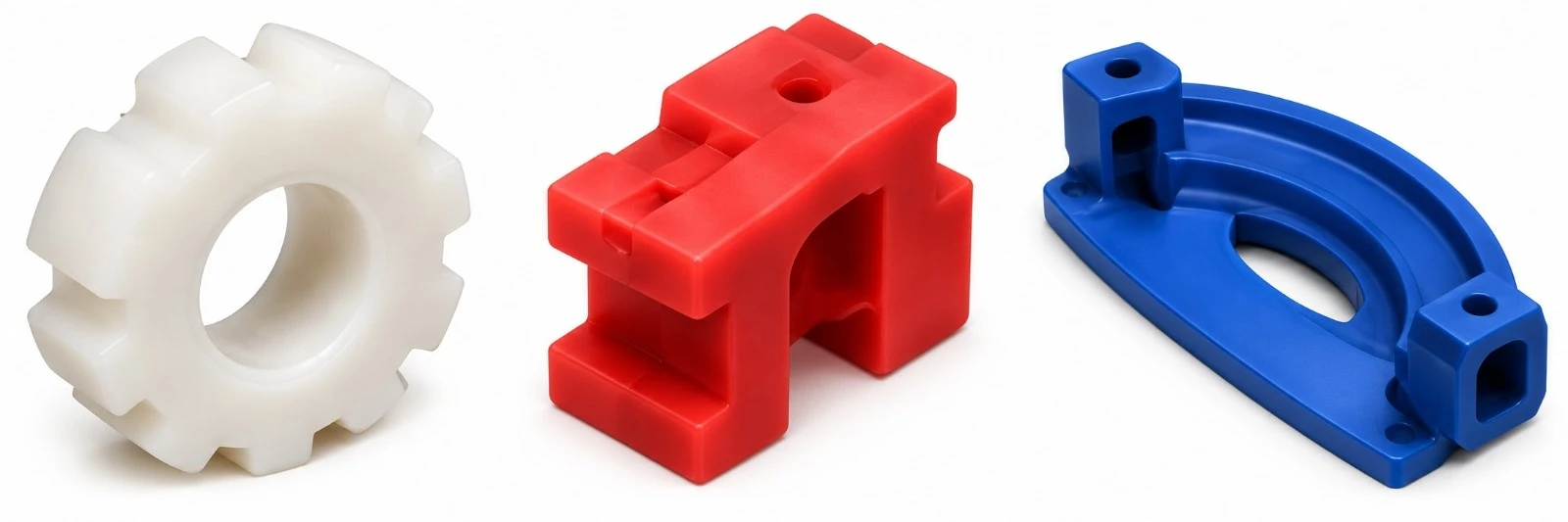 Examples of custom moulded silicone components — white gear, red bracket and blue bracket